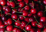close up of a bunch of bright red cherries shot from above