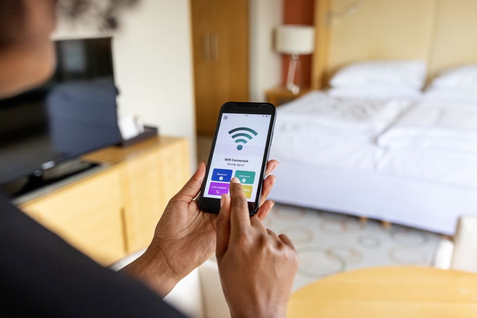 close up of a businesswoman connecting to the mobile wifi in hotel room
