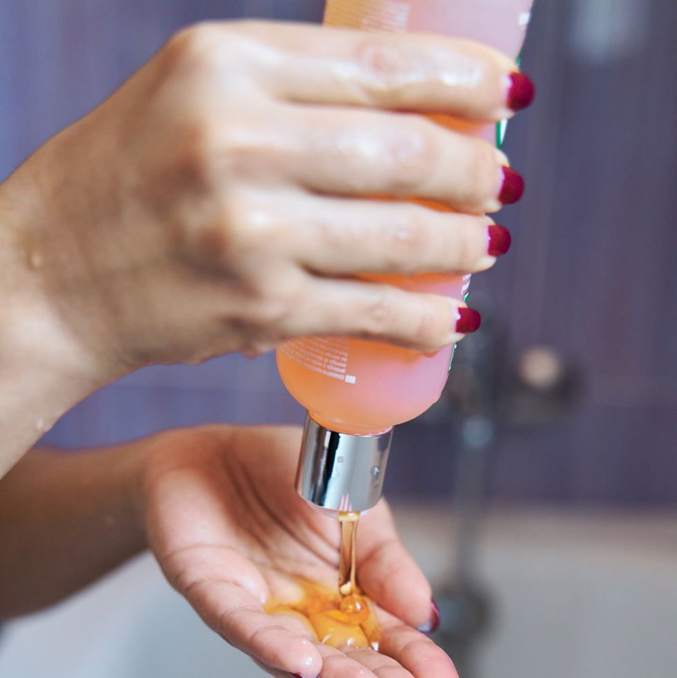 closeup of a female hand holding a shampoo or soap