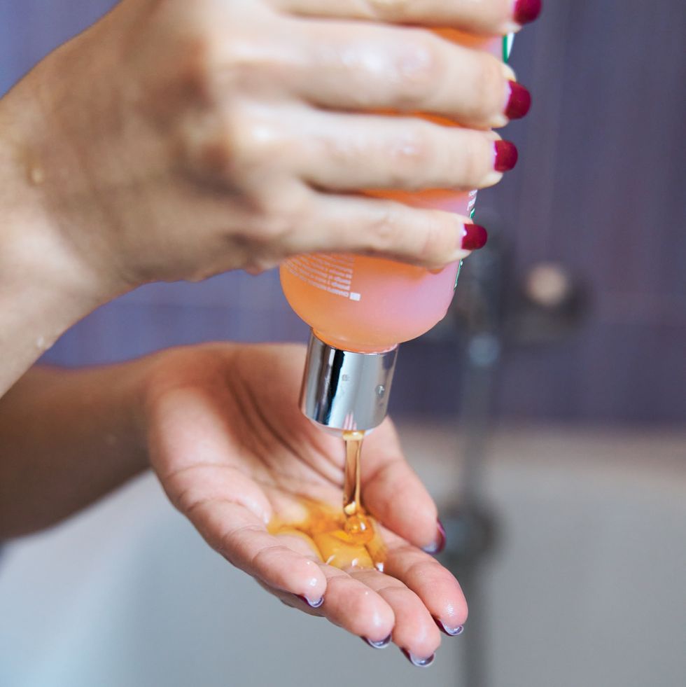 closeup of a female hand holding a shampoo or soap