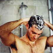 close-up of a man washing his hair in the shower