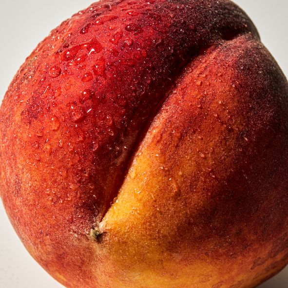 close up of a peach on white background