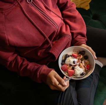 close up of a teenager with a bowl of meusli and fruit