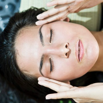 close up of a woman rubbing her temples