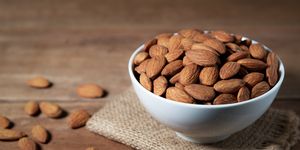 close up of almonds in bowl on table