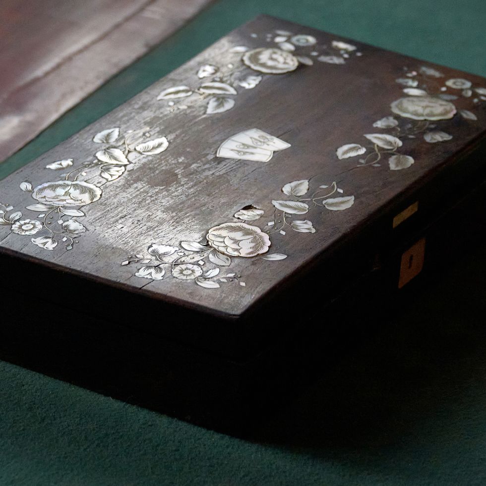 close up of an antique mother of pearl inlaid jewelry box