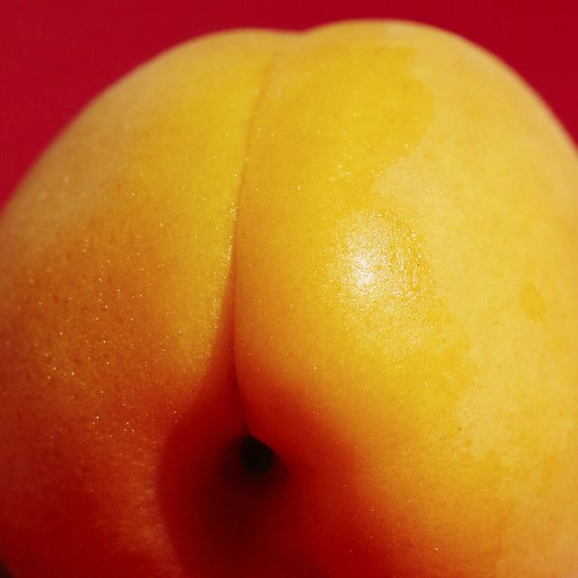 Close up of an apricot on a red background
