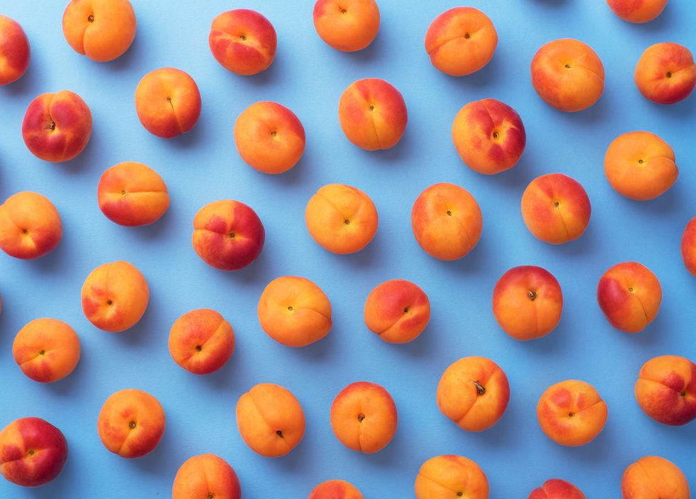 Close-Up Of Apricots On Blue Background