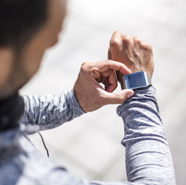 close up of athlete checking smartwatch