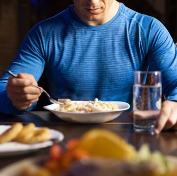closeup of athlete eating pasta dish