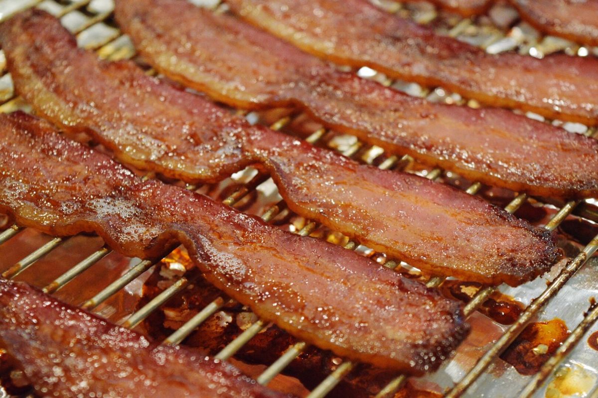 Close-Up Of Bacon Slices In Barbecue Grill