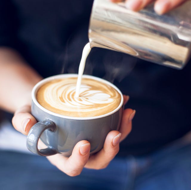 close up of barista holding coffee cup