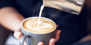 close up of barista holding coffee cup