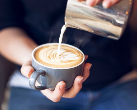 close up of barista holding coffee cup