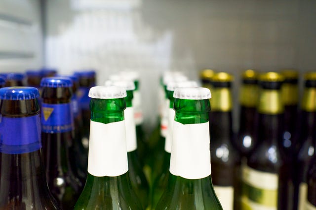 https://hips.hearstapps.com/hmg-prod/images/close-up-of-beer-bottles-with-white-cap-and-beers-royalty-free-image-1684506989.jpg?crop=0.668xw:1.00xh;0.128xw,0&resize=640:*