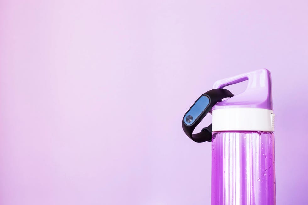 Close-Up Of Bottle Against Purple Background