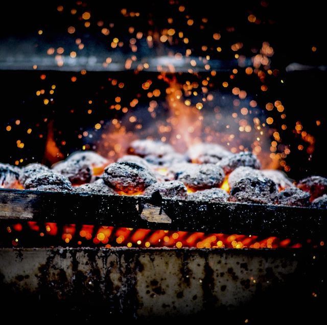 close up of burning coal on metal grill