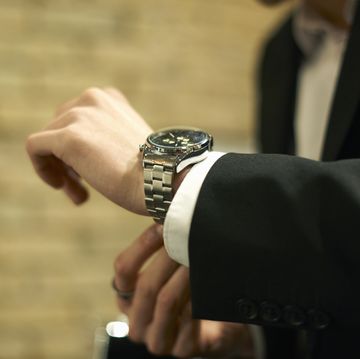 close up of businessman fastening wristwatch