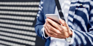 Close-up of businessman holding phone outdoors