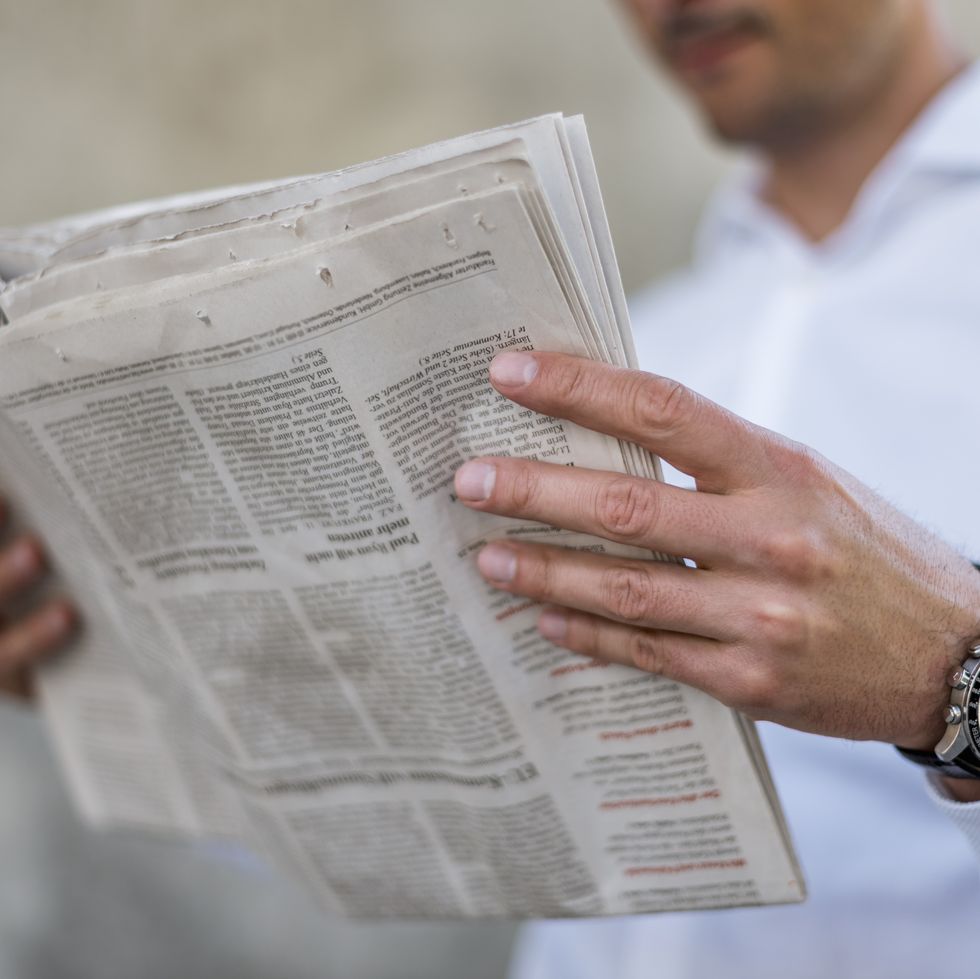 close up of businessman reading newspaper