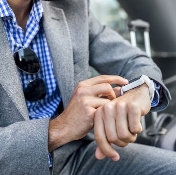Close-up of businessman using his smartwatch in the city