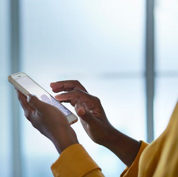 Close-up of businesswomans hands holding phone close up of businesswomans hands holding phone