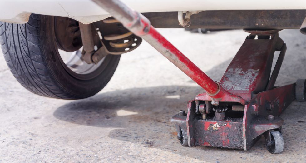 Close-Up Of Car Jack On Road