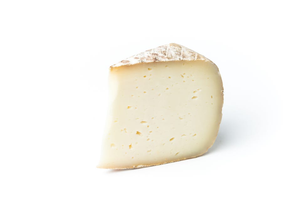 closeup of cheese slice against white background