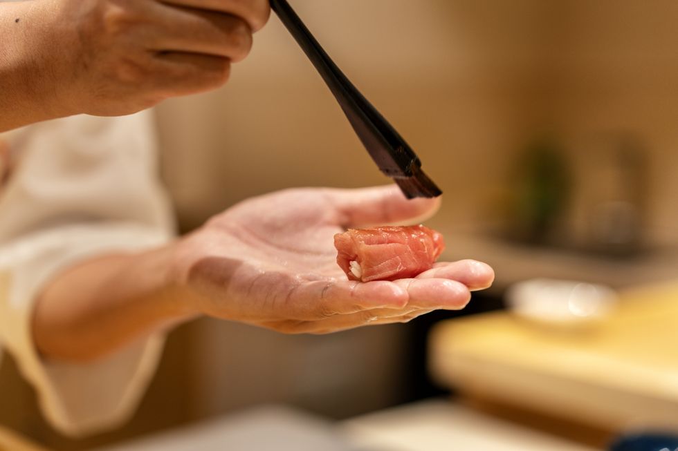 close up of chef making nigiri sushi