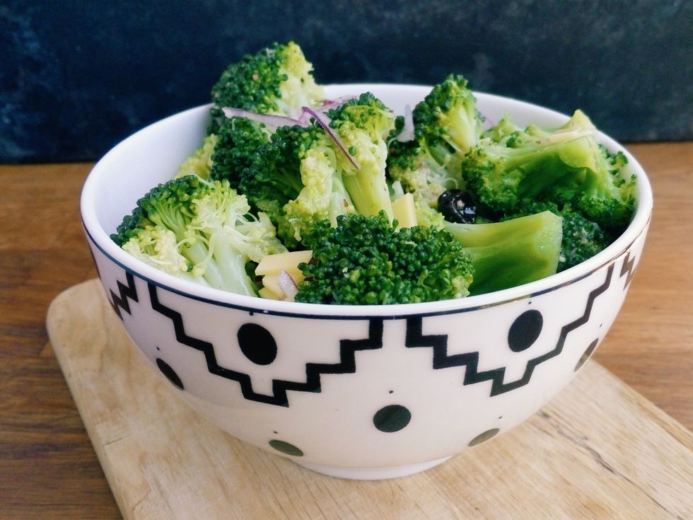 Close-Up Of Chopped Broccoli In Bowl On Cutting Board