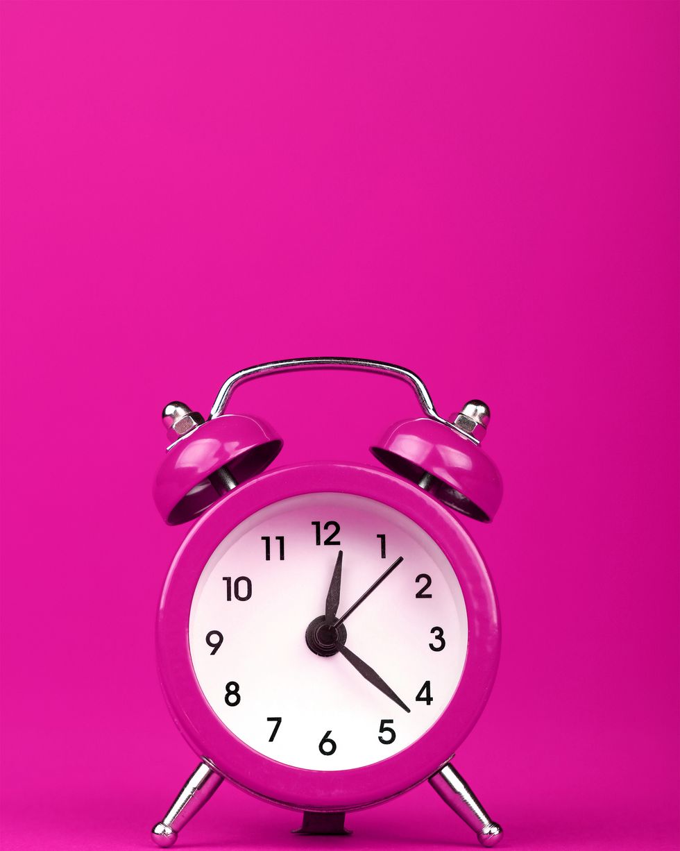Close-Up Of Clock On Pink Background