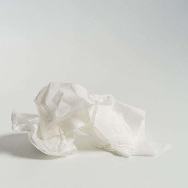 cold vs sinus infection  closeup of crumpled tissue against white background