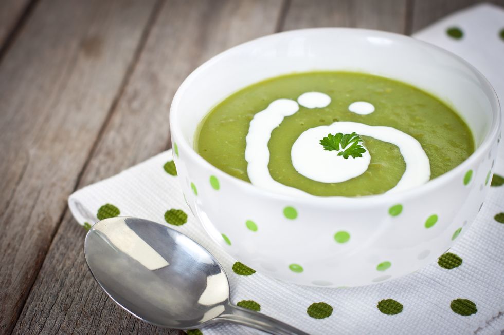 Close-up of decorated pea soup in a green dots napkin