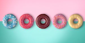 Close-Up Of Donuts Over Colored Background