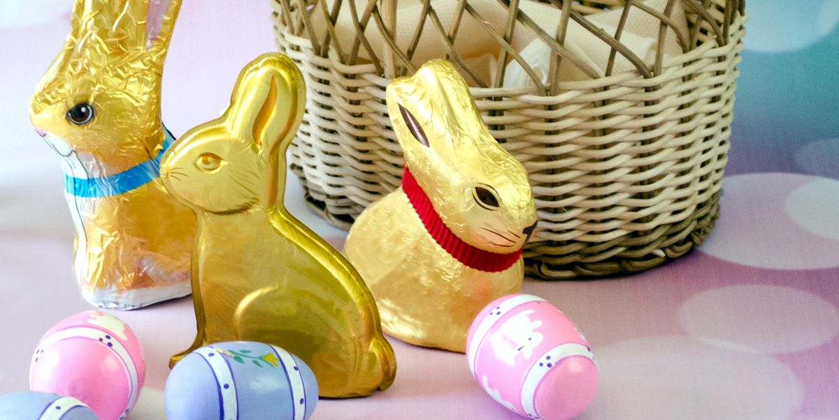 close up of easter bunnies with eggs and wicker basket against abstract backgrounds