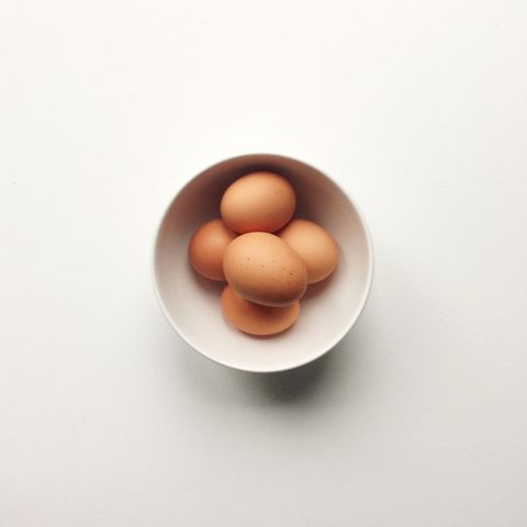 Close-up of eggs in bowl over white background