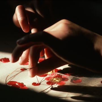 close up of embroidering flowers on silk, china