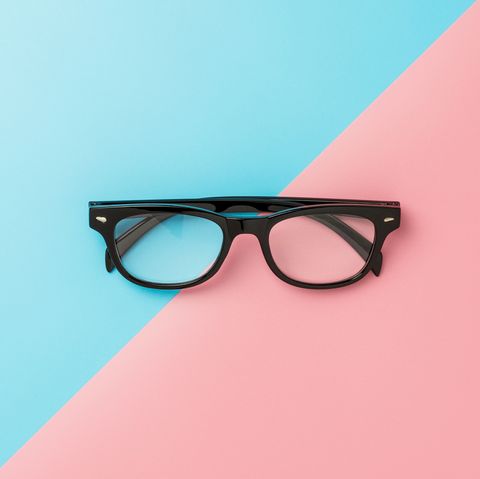 close up of eyeglasses on colored background