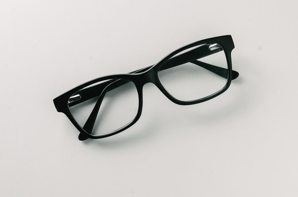 Close-Up Of Eyeglasses On Table Against White Background