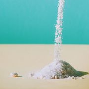 falling salt on surface against turquoise background