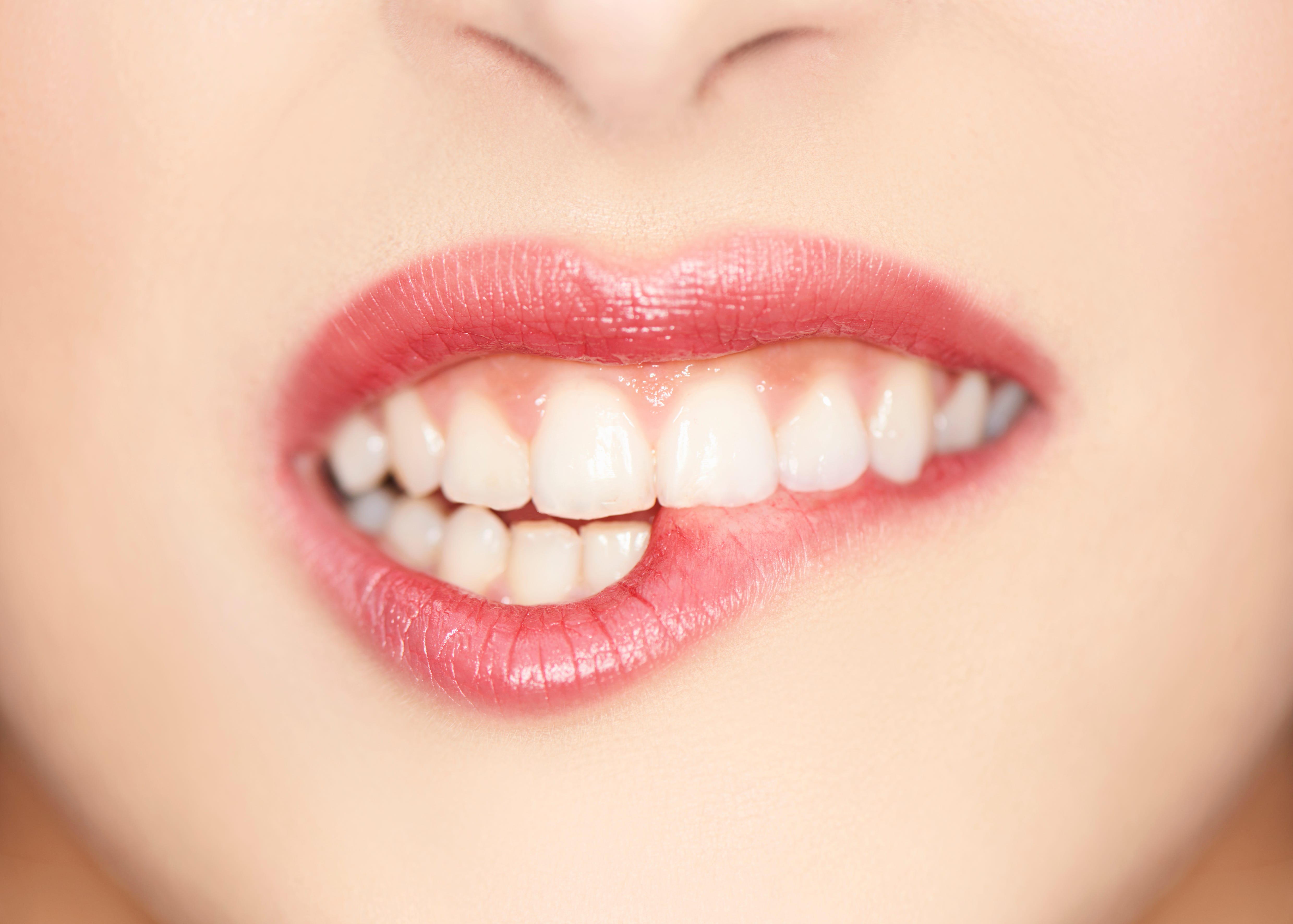 close up of female biting lips