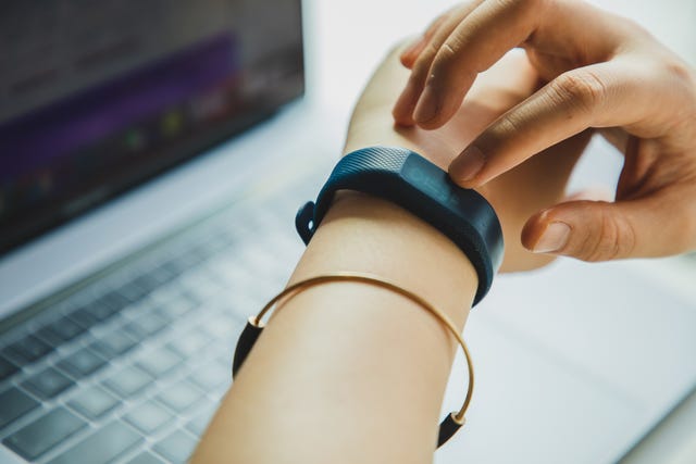 close up of female hand using a smart watch to check heart rate