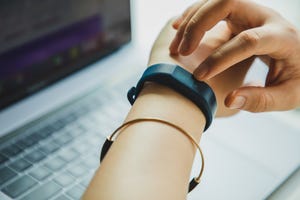 close up of female hand using a smart watch to check heart rate