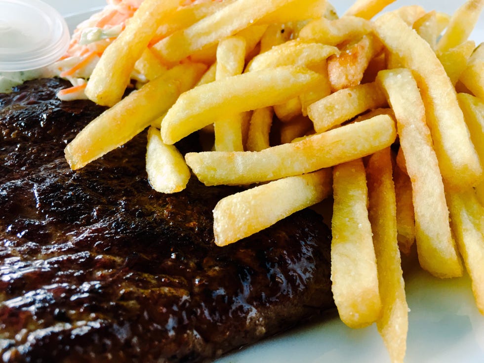Close-Up Of French Fries And Steak
