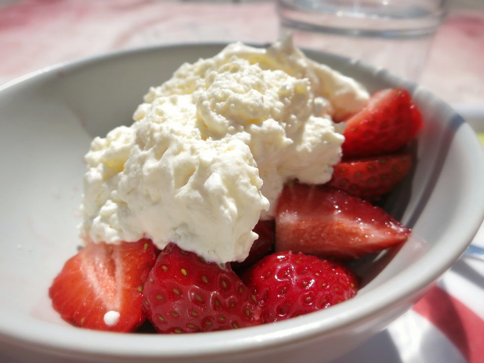 Close-up of fresh strawberry slices with curd cheese