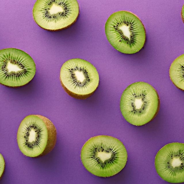 Close-Up Of Kiwi Fruits Over Purple Background