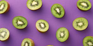 Close-Up Of Kiwi Fruits Over Purple Background