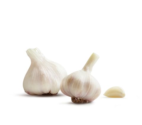 Close-Up Of Garlic Bulbs Against White Background