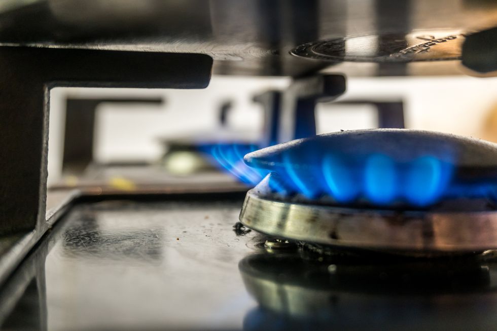 close up of gas stove burner and pot