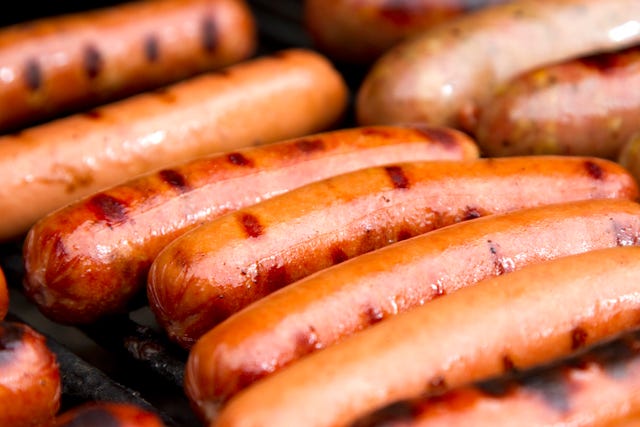 close up of grilled hotdogs on grill